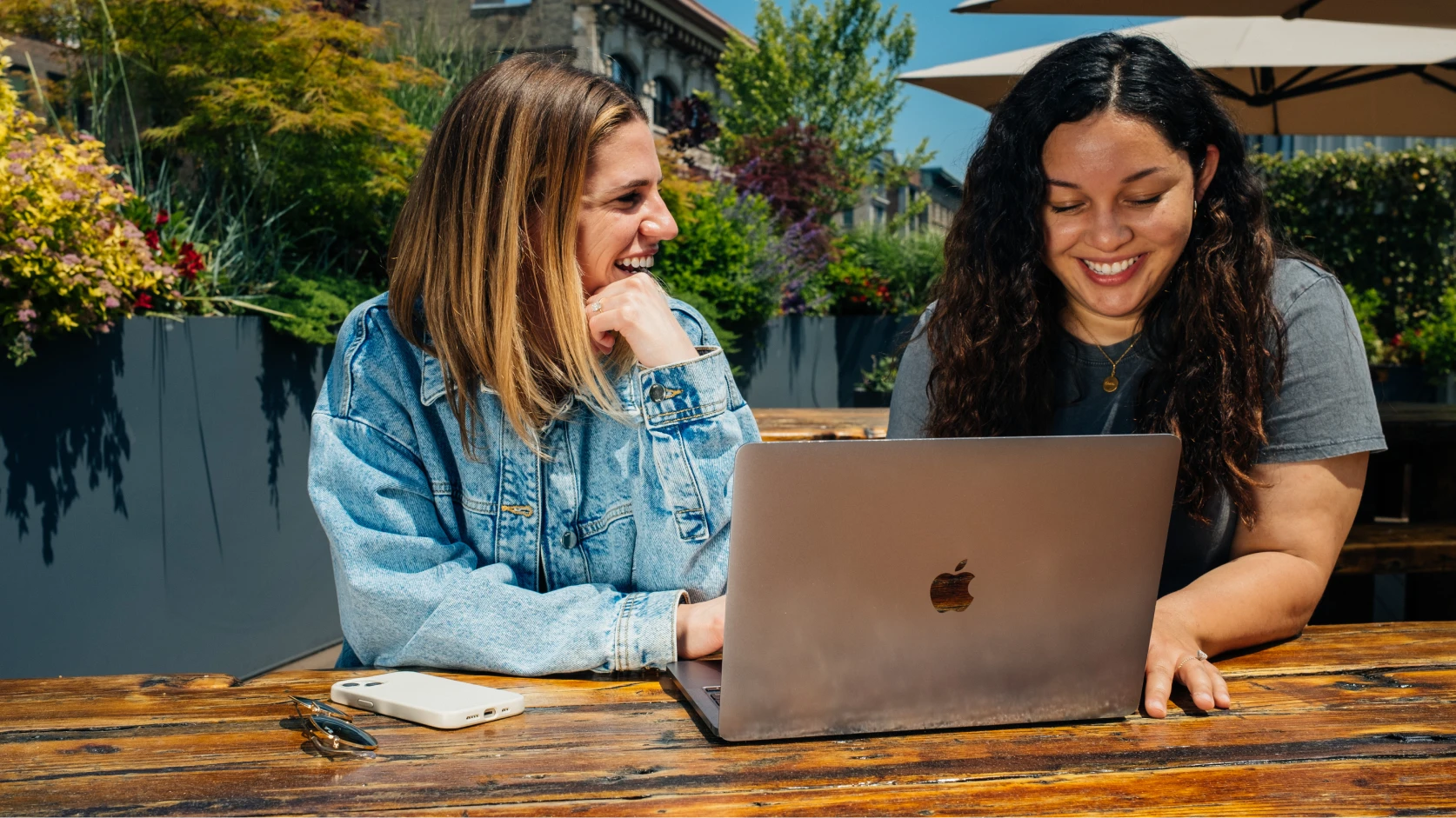 2 people working on a laptop